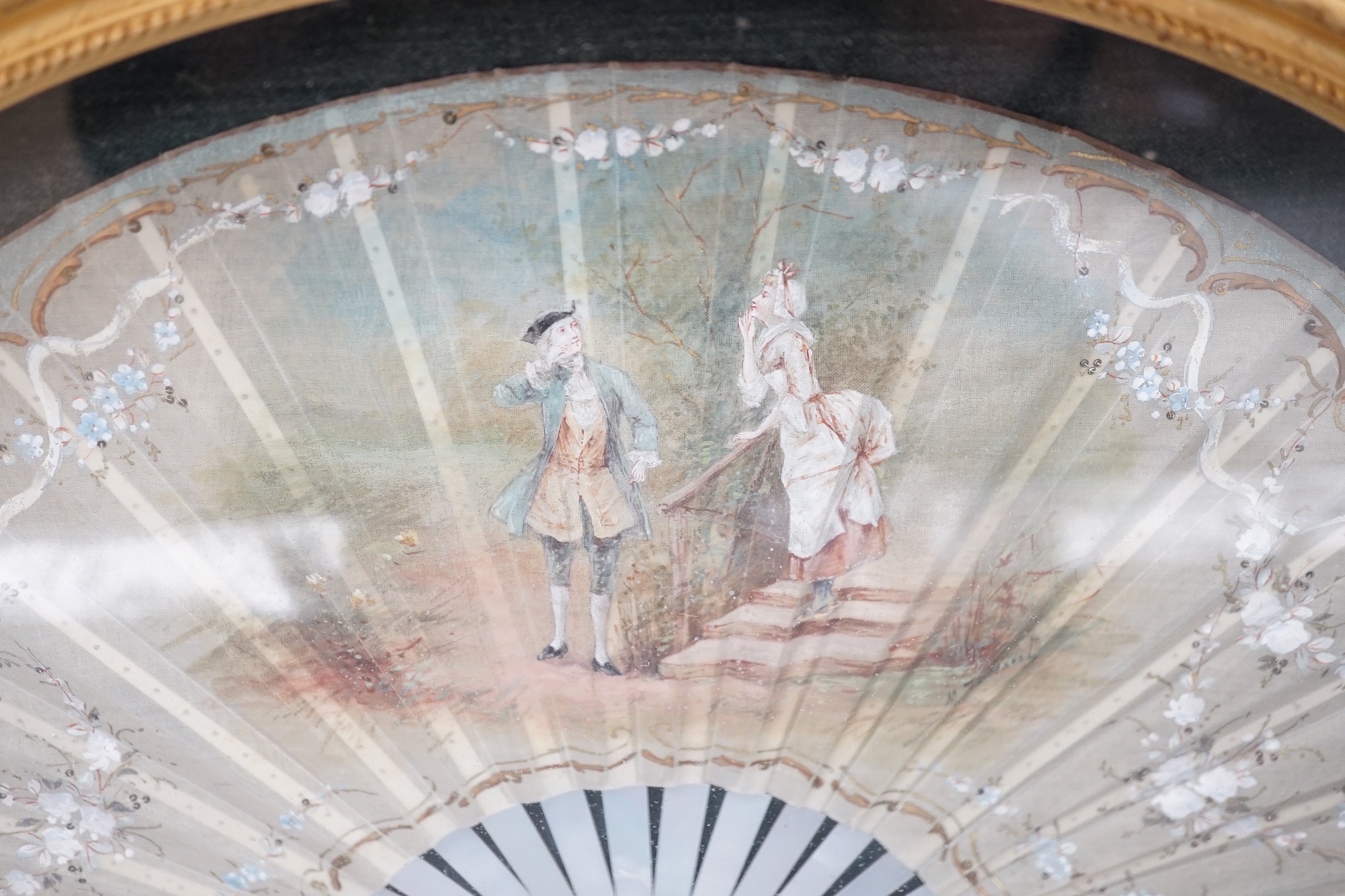 A framed Victorian figuratively painted fan with mother of pearl guards